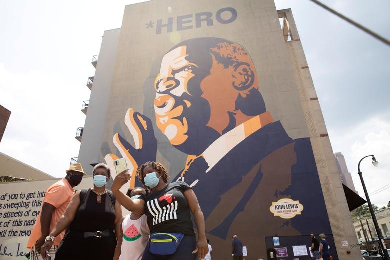 Mourners view a makeshift memorial to the passing of the late Rep. John Lewis, a pioneer of the civil rights movement and long-time member of the U.S. House of Representatives, under his mural in Atlanta, Georgia. REUTERS/Dustin Chambers 